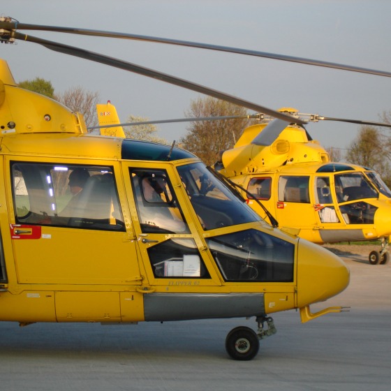 two yellow helicopters